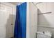 Bathroom with a shower stall and curtain, featuring a standard toilet and white walls at 21 W D St, Newton, NC 28658
