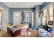 Bedroom featuring wood floors, an exterior door and two interior doors with neutral blue walls at 21 W D St, Newton, NC 28658