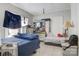 Bedroom featuring a blue bedspread, dresser with mirror, and a window for natural light at 21 W D St, Newton, NC 28658