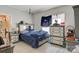 Bedroom with a dresser, nightstand, and a blue bedspread near a window at 21 W D St, Newton, NC 28658