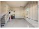 Spacious garage with unfinished walls, painted floor, stairs to storage, and natural light from a window at 21 W D St, Newton, NC 28658