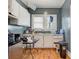 Kitchen with white cabinets, appliances, linoleum flooring, and a window above the countertop at 21 W D St, Newton, NC 28658
