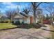 This single-story home features a brick chimney and a spacious backyard with mature trees at 21 W D St, Newton, NC 28658