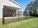 Fenced backyard with a covered patio and well-maintained lawn at 2108 Sabra St, Gastonia, NC 28054