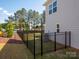 Fenced backyard with green lawn, and air conditioning unit behind the house at 2108 Sabra St, Gastonia, NC 28054