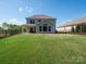 Spacious backyard featuring a covered patio and lush green lawn at 2108 Sabra St, Gastonia, NC 28054