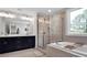Modern bathroom features a soaking tub and frameless glass shower at 2108 Sabra St, Gastonia, NC 28054