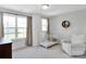 Bright Bedroom with large windows, a white crib, and a cozy armchair at 2108 Sabra St, Gastonia, NC 28054