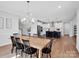 Open concept dining room and kitchen with wood floors and modern lighting at 2108 Sabra St, Gastonia, NC 28054