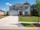 Beautiful two-story home with a two-car garage, landscaped yard, and charming curb appeal under a sunny sky at 2108 Sabra St, Gastonia, NC 28054