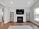 Comfortable living room with fireplace, TV, built-in shelves, and large window at 2108 Sabra St, Gastonia, NC 28054