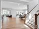 Open-concept living and dining area features hardwood floors, a staircase, and ample natural light at 2108 Sabra St, Gastonia, NC 28054
