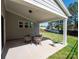 Covered outdoor patio with a table, chairs, and view of the backyard at 2108 Sabra St, Gastonia, NC 28054