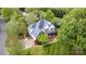 An aerial view of the home featuring a blue roof, large backyard, and pristine landscaping at 212 Horn Tassel Ct, Indian Trail, NC 28079