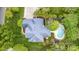 An aerial view shows the home with a backyard swimming pool, patio, and mature tree coverage at 212 Horn Tassel Ct, Indian Trail, NC 28079