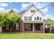 Charming two-story home with brick accents, covered porch, and well-manicured front yard at 212 Horn Tassel Ct, Indian Trail, NC 28079