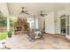 Covered patio with stone fireplace, ceiling fans, and a dining table and chairs at 212 Horn Tassel Ct, Indian Trail, NC 28079