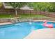 Backyard pool with stone accents, water features and a flamingo floatie at 212 Horn Tassel Ct, Indian Trail, NC 28079
