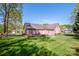 The spacious backyard of this brick home features a patio and manicured lawn at 227 Donsdale Dr, Statesville, NC 28625