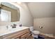 Compact half-bathroom featuring a modern vanity, neutral decor, and efficient use of space at 227 Donsdale Dr, Statesville, NC 28625