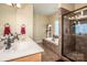 Well-designed bathroom with double sinks, walk-in shower, and soaking tub at 227 Donsdale Dr, Statesville, NC 28625
