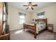 Charming bedroom with a wooden bed frame, complemented by natural light from the window at 227 Donsdale Dr, Statesville, NC 28625