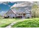 Charming brick home featuring a well-manicured lawn and inviting stone walkway and lush landscaping at 227 Donsdale Dr, Statesville, NC 28625