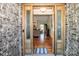 View through the decorated wooden front door showing the gleaming hardwood floors into the living space at 227 Donsdale Dr, Statesville, NC 28625