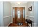 Welcoming foyer featuring a decorative front door, hardwood floors, and elegant lighting at 227 Donsdale Dr, Statesville, NC 28625