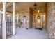 Inviting front porch with brick columns, lovely decor, and a beautiful wood door entrance at 227 Donsdale Dr, Statesville, NC 28625