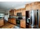 Modern kitchen with stainless steel appliances, wooden cabinetry, and granite countertops at 227 Donsdale Dr, Statesville, NC 28625