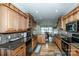 Open kitchen with wooden cabinetry, granite countertops, and a view to the dining room at 227 Donsdale Dr, Statesville, NC 28625