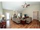 Cozy living room with hardwood floors, a fireplace, and neutral decor with vaulted ceiling at 227 Donsdale Dr, Statesville, NC 28625