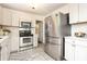 This kitchen boasts stainless steel appliances, including a French door refrigerator at 2413 Bergen Ct, Charlotte, NC 28210