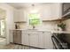 Updated kitchen featuring white cabinets, stainless appliances, and ample counter space at 2413 Bergen Ct, Charlotte, NC 28210