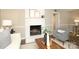 Comfortable living room featuring a brick fireplace, hardwood floors, and stylish decor at 2413 Bergen Ct, Charlotte, NC 28210