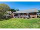 Brick home featuring a backyard with a large grassy area and a wooden deck, perfect for outdoor enjoyment at 2426 36Th Ne Ave, Hickory, NC 28601