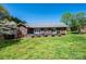 Brick home featuring a backyard with a large grassy area and a wooden deck, perfect for outdoor enjoyment at 2426 36Th Ne Ave, Hickory, NC 28601