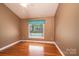 A cozy bedroom features wood floors, a ceiling fan, and a window to let the light shine in at 2426 36Th Ne Ave, Hickory, NC 28601