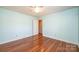 A cozy bedroom boasts hardwood floors, a ceiling fan, and neutral colored walls at 2426 36Th Ne Ave, Hickory, NC 28601