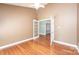A cozy bedroom featuring wood floors, a ceiling fan, and a glass door to let the light shine in at 2426 36Th Ne Ave, Hickory, NC 28601