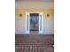 Close-up of the front door with sidelights and brickwork, creating a welcoming entrance at 2426 36Th Ne Ave, Hickory, NC 28601