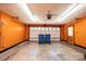 Bright garage with orange walls, a garage door, and a side entrance door at 2426 36Th Ne Ave, Hickory, NC 28601
