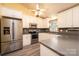 A kitchen featuring stainless steel appliances, gray countertops, white cabinets, and a ceiling fan at 2426 36Th Ne Ave, Hickory, NC 28601