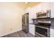 Kitchen features stainless steel appliances, gray countertops, white cabinets, and a ceiling fan at 2426 36Th Ne Ave, Hickory, NC 28601
