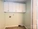 Laundry room with cabinets above the washer/dryer hookups and tile flooring at 2426 36Th Ne Ave, Hickory, NC 28601