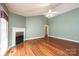 Cozy living room with a decorative fireplace, hardwood floors, and a ceiling fan at 2426 36Th Ne Ave, Hickory, NC 28601