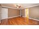 A large main bedroom boasts hardwood floors, a ceiling fan, and neutral colored walls at 2426 36Th Ne Ave, Hickory, NC 28601