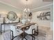 Elegant dining area showcasing wainscoting, stylish decor, and a seamless flow to other living spaces at 2803 Morning Song Way, Lancaster, SC 29720