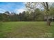 Expansive backyard featuring a lush green lawn, mature trees, and a serene natural setting at 2825 Old Pageland Marshville Rd, Wingate, NC 28174